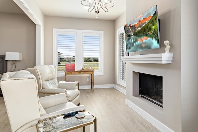 sitting room with a chandelier and light hardwood / wood-style floors