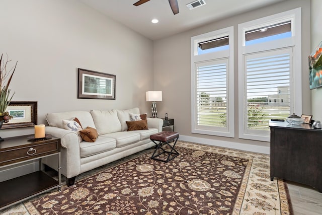 living room featuring ceiling fan, plenty of natural light, and hardwood / wood-style floors