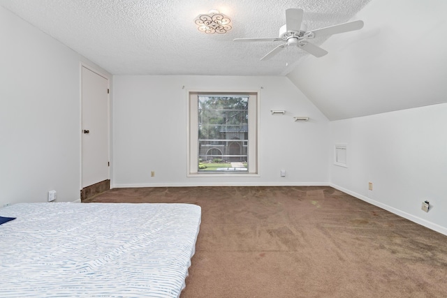 carpeted bedroom featuring ceiling fan, lofted ceiling, and a textured ceiling