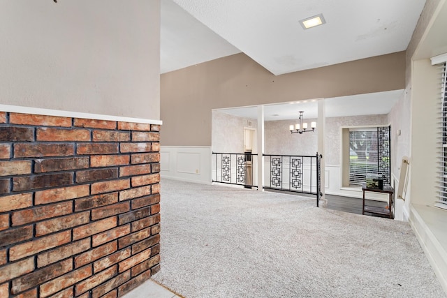 carpeted living room featuring a notable chandelier