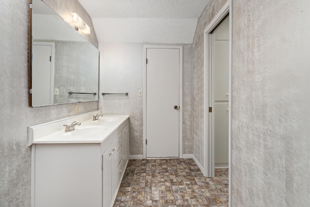 bathroom with vanity and a textured ceiling