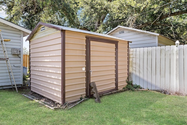 view of outbuilding featuring a lawn