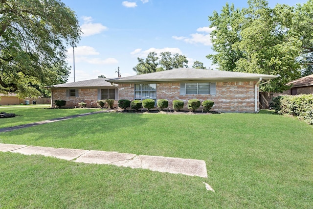 ranch-style home with a front lawn