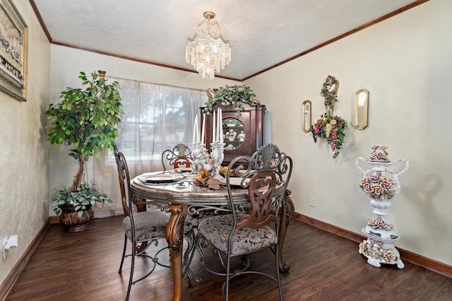 dining space with dark hardwood / wood-style floors, ornamental molding, and a chandelier