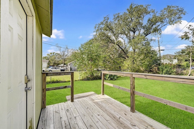 wooden terrace featuring a yard