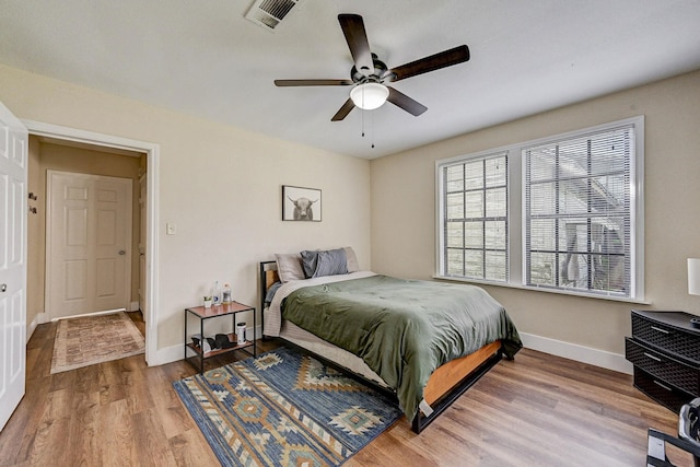 bedroom with wood-type flooring and ceiling fan