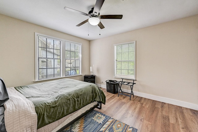 bedroom with ceiling fan and light wood-type flooring