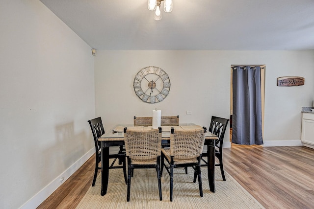 dining space with light hardwood / wood-style flooring