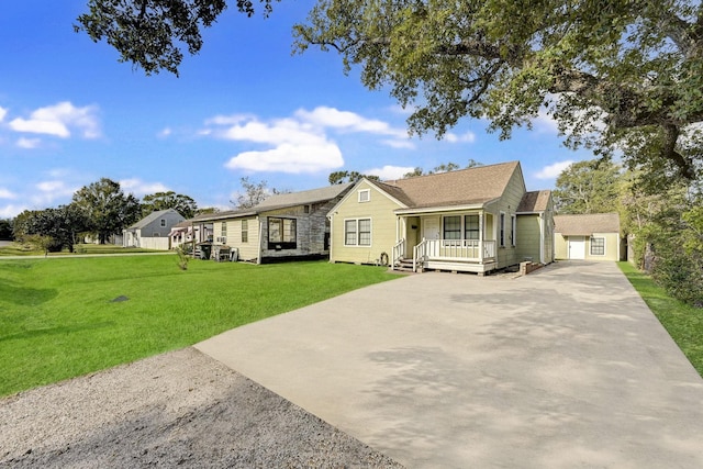 view of front of home with a front yard, a porch, and an outdoor structure