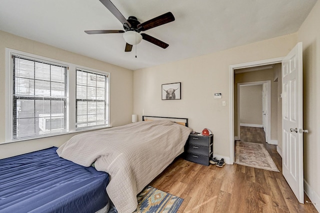 bedroom with ceiling fan and light hardwood / wood-style flooring