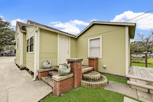 rear view of house featuring a wooden deck