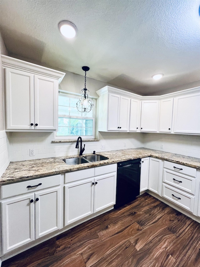 2411 Post Oak Ln, Groves, TX 77619 - kitchen featuring black dishwasher, white cabinetry, dark wood-style floors, a textured ceiling, and light stone counters