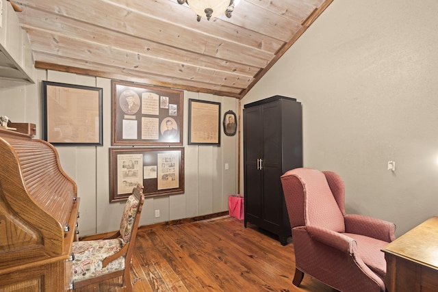sitting room with baseboards, vaulted ceiling, hardwood / wood-style flooring, and wooden ceiling