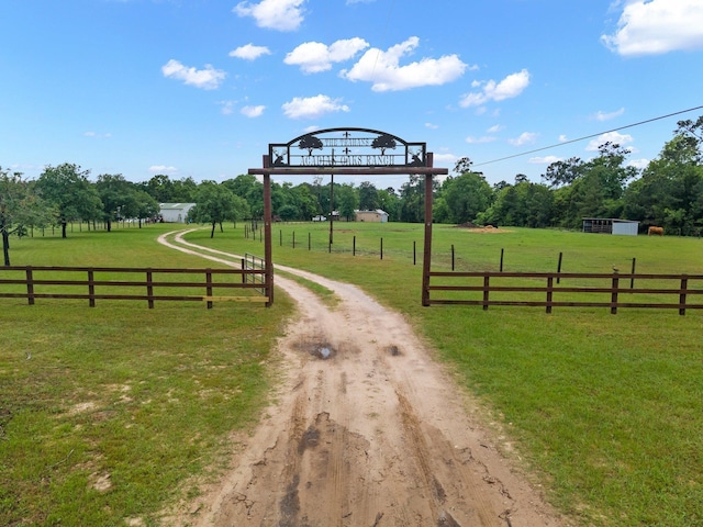 view of road with driveway and a rural view