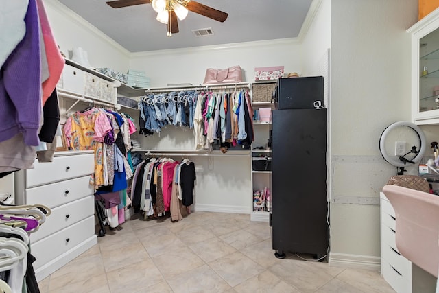 walk in closet with ceiling fan and light tile patterned flooring