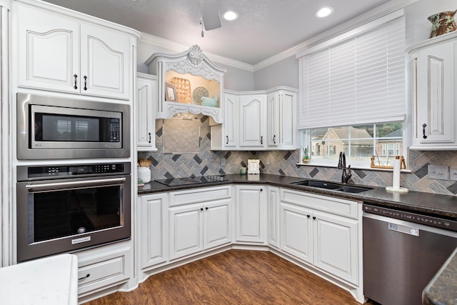 kitchen with crown molding, sink, appliances with stainless steel finishes, dark hardwood / wood-style flooring, and white cabinetry