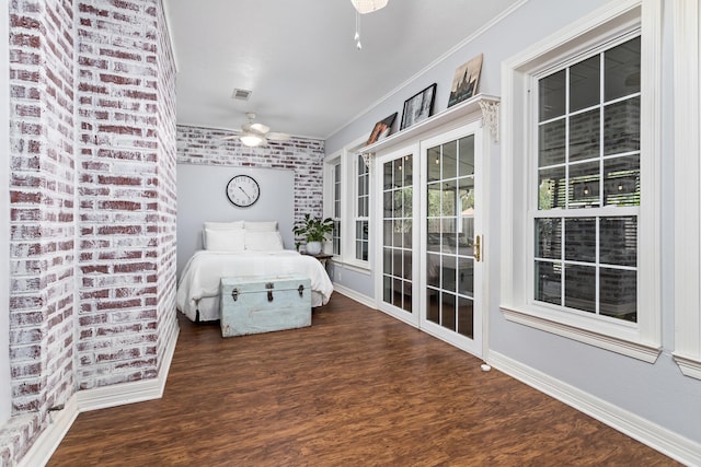 unfurnished bedroom with dark hardwood / wood-style floors, crown molding, and brick wall