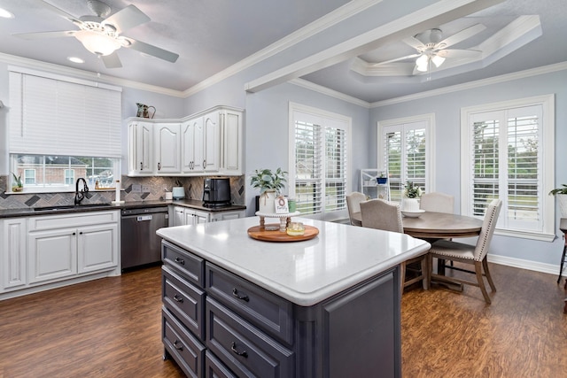 kitchen with white cabinetry, dishwasher, crown molding, and sink