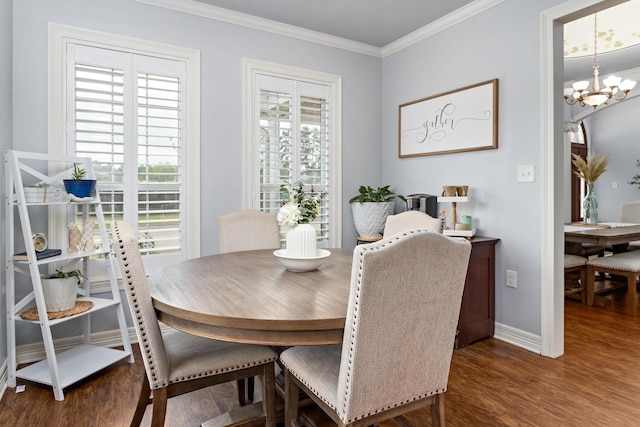 dining room featuring dark hardwood / wood-style flooring, crown molding, and an inviting chandelier