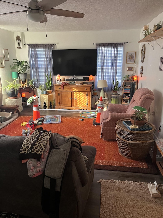 living room featuring a textured ceiling and ceiling fan