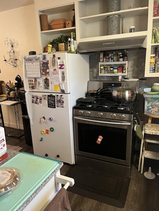 kitchen with wall chimney exhaust hood, white fridge, gas stove, and dark hardwood / wood-style floors