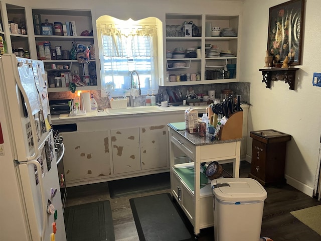 kitchen featuring white cabinetry, sink, dark hardwood / wood-style floors, and white refrigerator