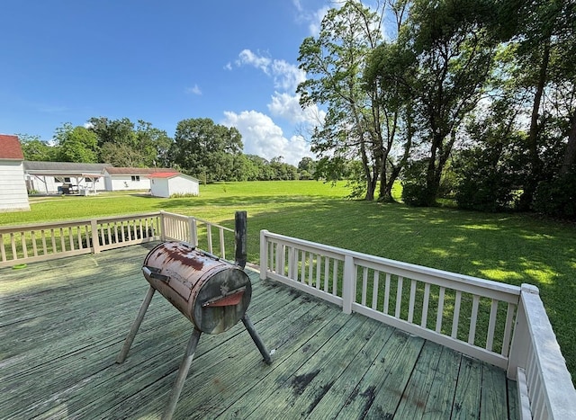 wooden terrace featuring a yard