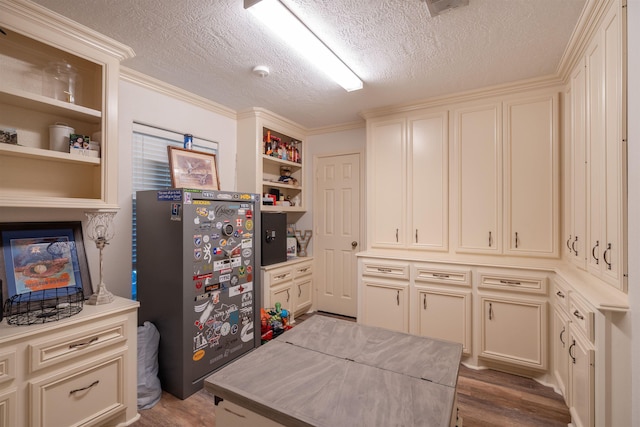 kitchen featuring dark wood-type flooring, light countertops, open shelves, and a textured ceiling