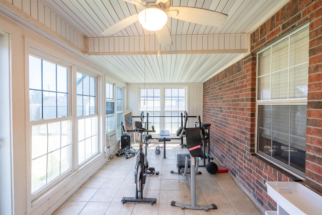 workout area with brick wall, tile patterned flooring, wooden ceiling, and ceiling fan