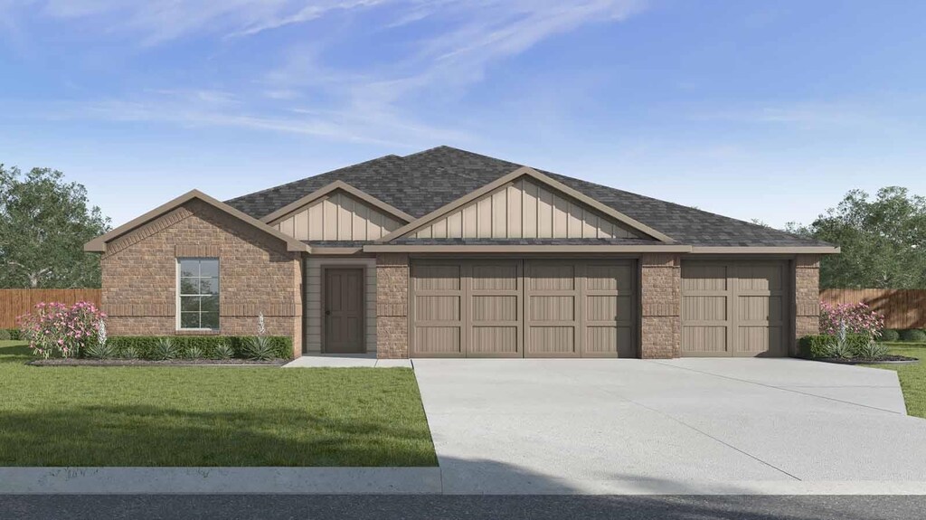 1705 Holly Trl, Sour Lake, TX 77659 - view of front of property featuring fence, a front lawn, a garage, board and batten siding, and brick siding