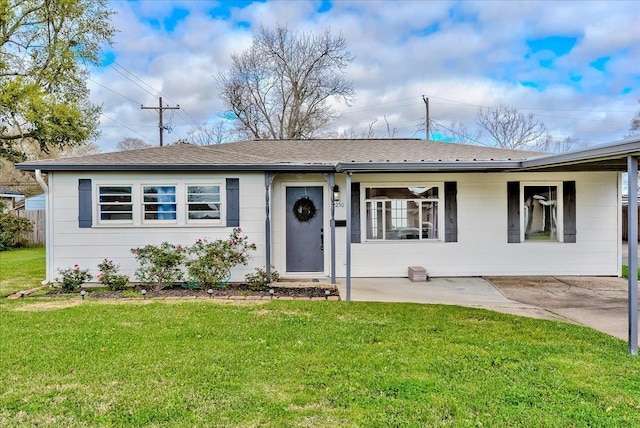 single story home featuring a shingled roof and a front lawn