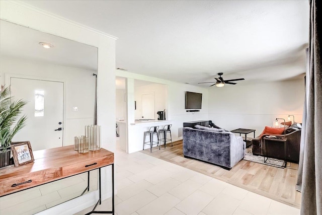 living area featuring visible vents, ceiling fan, and wood finished floors