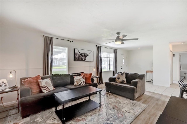 living area with light wood-style flooring and ceiling fan