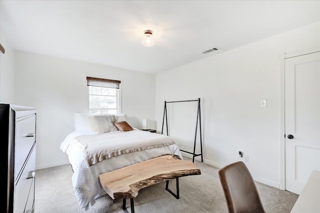 bedroom with baseboards, light carpet, and visible vents