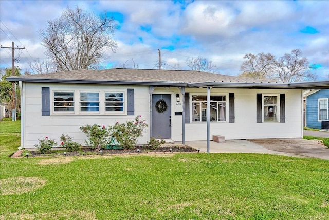 ranch-style home with cooling unit, a front lawn, and roof with shingles