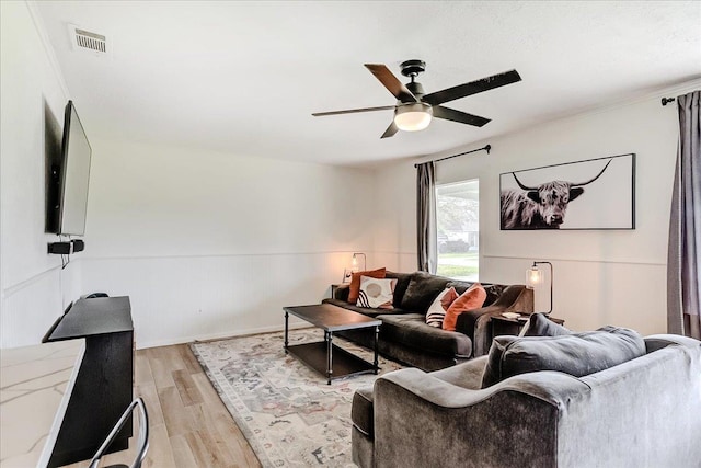 living area featuring visible vents, ceiling fan, and light wood-style floors