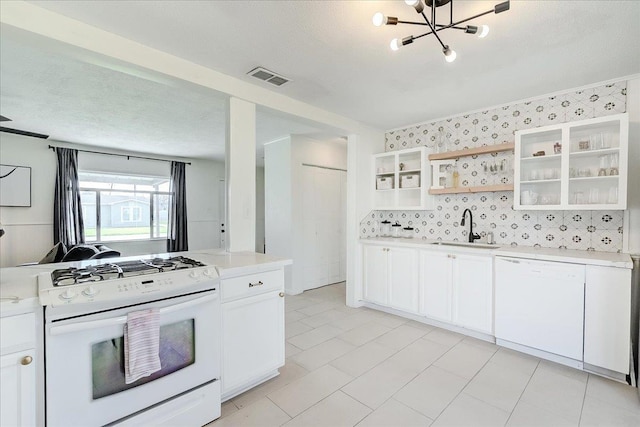 kitchen featuring white appliances, open shelves, a sink, light countertops, and white cabinetry