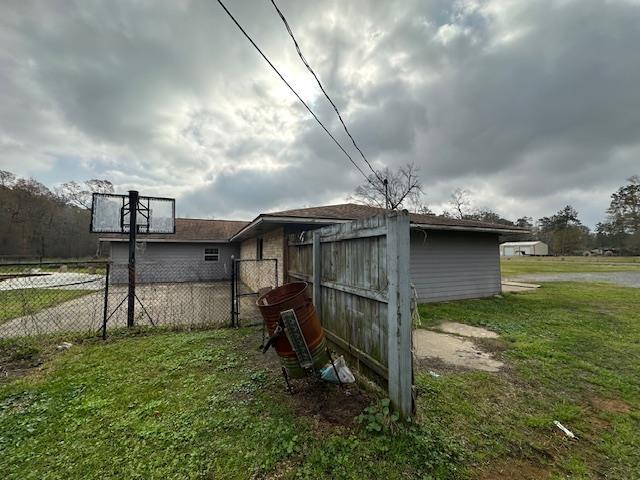 view of outbuilding featuring fence