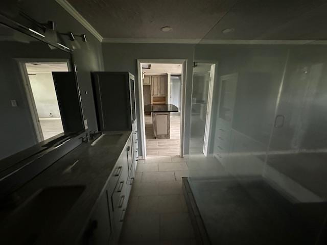 bathroom with ornamental molding, a sink, and tile patterned floors