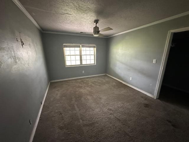 spare room with ornamental molding, carpet, baseboards, a textured ceiling, and ceiling fan
