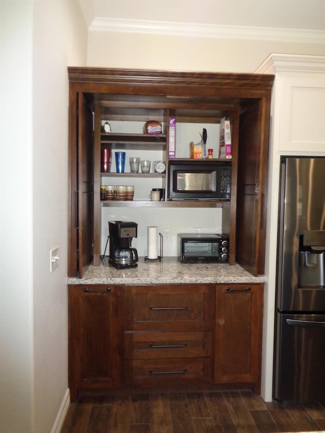 bar with ornamental molding, a toaster, black microwave, stainless steel fridge with ice dispenser, and dark wood-style flooring