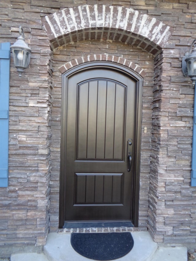 entrance to property with stone siding