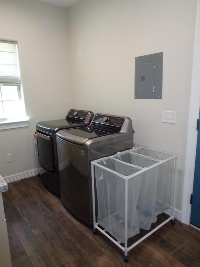 laundry room featuring dark wood-type flooring, baseboards, electric panel, laundry area, and separate washer and dryer