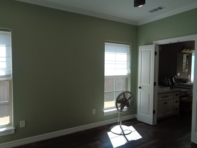 bedroom featuring dark wood finished floors, baseboards, visible vents, and ornamental molding