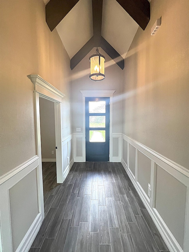 entrance foyer featuring dark hardwood / wood-style floors and vaulted ceiling