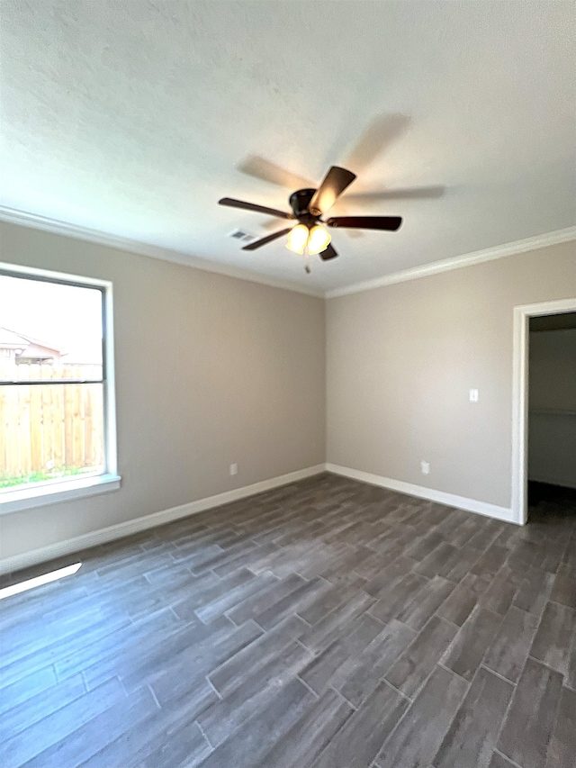 unfurnished room with ceiling fan, dark hardwood / wood-style flooring, and ornamental molding