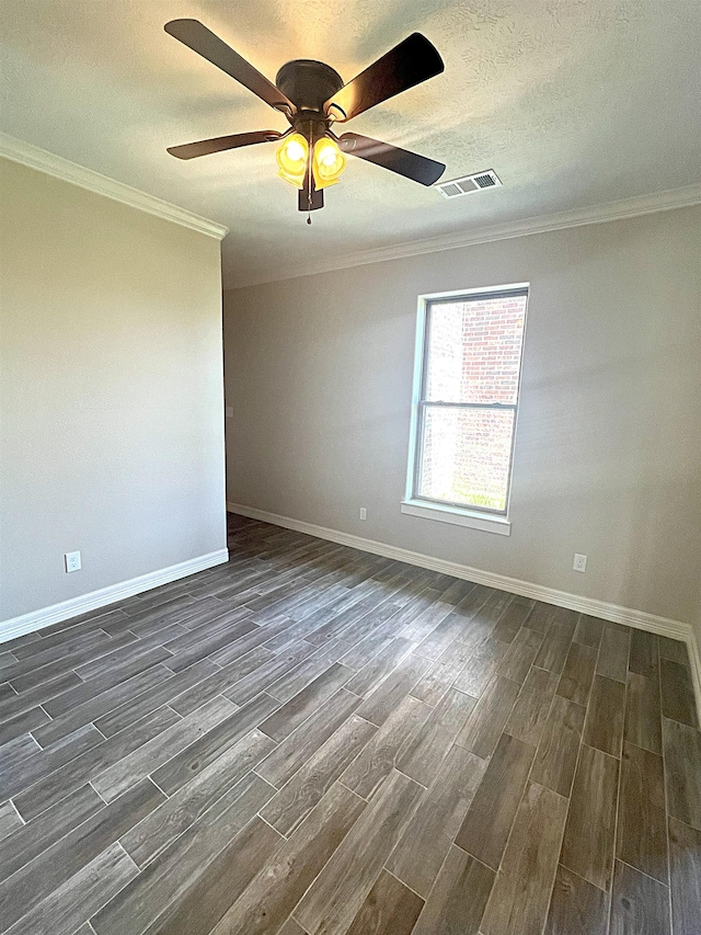 unfurnished room with a textured ceiling, ceiling fan, ornamental molding, and dark wood-type flooring