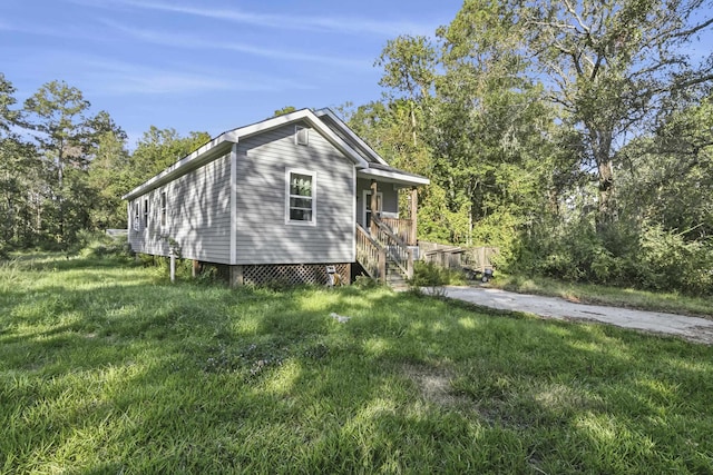 view of side of home featuring a lawn