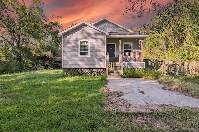 view of front of house featuring a lawn and a porch