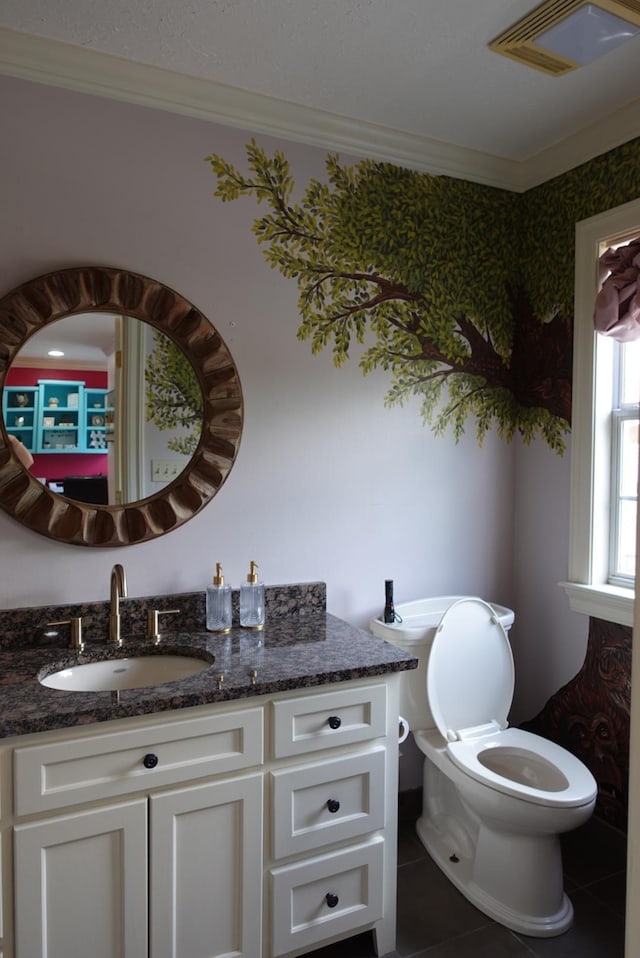 7840 Halliday St, Beaumont, TX 77706 - bathroom with vanity, tile patterned floors, crown molding, and toilet